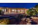 Backyard with covered patio and water feature at dusk at 22208 N San Ramon Dr, Sun City West, AZ 85375