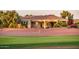 Exterior view of home backing up to golf course, landscaped backyard with desertscape at 22208 N San Ramon Dr, Sun City West, AZ 85375