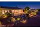 Backyard with mature landscaping and water feature at night at 22208 N San Ramon Dr, Sun City West, AZ 85375