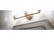Gold bathroom lighting fixture above a frameless beveled mirror at 22208 N San Ramon Dr, Sun City West, AZ 85375