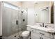 Bright bathroom featuring white cabinets, granite countertops, and a glass-enclosed shower at 22208 N San Ramon Dr, Sun City West, AZ 85375