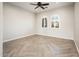 Bright, empty bedroom with herringbone wood floors and large arched windows featuring bright outdoor views at 22208 N San Ramon Dr, Sun City West, AZ 85375
