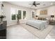 This bedroom features natural light with a decorative ceiling fan, and herringbone wood floors at 22208 N San Ramon Dr, Sun City West, AZ 85375
