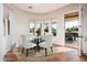 Breakfast nook with round table, chairs, and views of the landscaped backyard at 22208 N San Ramon Dr, Sun City West, AZ 85375