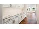 Butlers pantry with custom white cabinets and granite countertops at 22208 N San Ramon Dr, Sun City West, AZ 85375