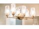 Stylish chandelier fixture with crystal shades and gold accents at 22208 N San Ramon Dr, Sun City West, AZ 85375