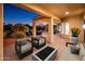 Outdoor living on the covered patio offers relaxed seating, fireplace and scenic views at 22208 N San Ramon Dr, Sun City West, AZ 85375