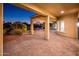 A spacious covered patio features brick pavers and offers serene views of the expertly landscaped yard at 22208 N San Ramon Dr, Sun City West, AZ 85375