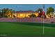 Beautiful single-story home on a golf course with mature landscaping at dusk at 22208 N San Ramon Dr, Sun City West, AZ 85375