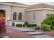 Exterior elevation of home with manicured shrubs and landscape lighting at 22208 N San Ramon Dr, Sun City West, AZ 85375