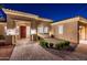 Beautiful front entrance with brick pavers, potted plants, and a well-maintained landscape at 22208 N San Ramon Dr, Sun City West, AZ 85375