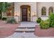 Charming home featuring brick walkway, desert landscaping, and a covered front entryway at 22208 N San Ramon Dr, Sun City West, AZ 85375