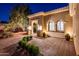 Front entrance showcasing brick pavers, manicured bushes, and tasteful outdoor lighting at 22208 N San Ramon Dr, Sun City West, AZ 85375