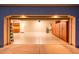 View of the well-lit garage, featuring epoxy floors, storage, and high ceilings at 22208 N San Ramon Dr, Sun City West, AZ 85375