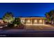Exterior view showcasing a spacious three-car garage with an expansive driveway and lush landscaping at 22208 N San Ramon Dr, Sun City West, AZ 85375