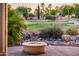 Picturesque golf course view from a patio featuring a fire pit and desert landscaping at 22208 N San Ramon Dr, Sun City West, AZ 85375