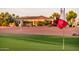 The flag with the logo of the Corte Bella Golf Club is planted on the green at 22208 N San Ramon Dr, Sun City West, AZ 85375