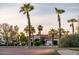 Beautiful view of Corte Bella Golf Club with palm trees in foreground and lush landscaping at 22208 N San Ramon Dr, Sun City West, AZ 85375