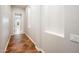 Hallway with ceramic tile flooring, white walls and trim, and art niches provides a clean and bright pathway at 22208 N San Ramon Dr, Sun City West, AZ 85375