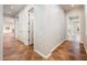 Hallway with tile floors, white trim, and open doorway provides a bright passageway to the home's interior at 22208 N San Ramon Dr, Sun City West, AZ 85375
