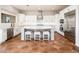 White kitchen features an island with seating and stainless steel appliances at 22208 N San Ramon Dr, Sun City West, AZ 85375