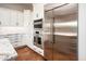 Modern kitchen with stainless steel refrigerator and appliances, and white cabinets at 22208 N San Ramon Dr, Sun City West, AZ 85375