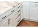 Close-up showing white cabinets with dark hardware and countertops in the kitchen at 22208 N San Ramon Dr, Sun City West, AZ 85375