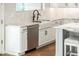 Kitchen with stainless dishwasher, farmhouse sink, and white cabinets at 22208 N San Ramon Dr, Sun City West, AZ 85375