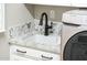 Granite countertops above white cabinets next to new washing machine in laundry room at 22208 N San Ramon Dr, Sun City West, AZ 85375