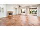 Living room with tiled fireplace and access to an outdoor patio at 22208 N San Ramon Dr, Sun City West, AZ 85375