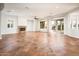 Open-concept living room with fireplace, recessed lighting, neutral colors, and patio access at 22208 N San Ramon Dr, Sun City West, AZ 85375
