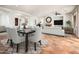 Bright living room featuring a dining area, fireplace, and comfortable seating at 22208 N San Ramon Dr, Sun City West, AZ 85375