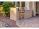 Outdoor kitchen featuring a stainless steel grill, granite countertop, and convenient storage at 22208 N San Ramon Dr, Sun City West, AZ 85375