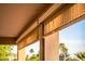 Covered patio with retractable shades, offering shade and privacy with a view to the lush backyard at 22208 N San Ramon Dr, Sun City West, AZ 85375
