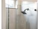 Shower with gray tile and frameless glass door and window at 22208 N San Ramon Dr, Sun City West, AZ 85375