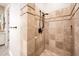 Walk-in shower with decorative tile and black fixtures complements the natural aesthetic of the room at 22208 N San Ramon Dr, Sun City West, AZ 85375