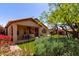 Charming backyard featuring lush landscaping, a covered patio, and a well-maintained lawn at 22232 N 48Th St, Phoenix, AZ 85054