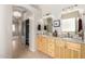 Bathroom with double sinks, granite countertops, and modern lighting fixtures at 22232 N 48Th St, Phoenix, AZ 85054