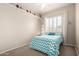 Bright bedroom featuring a ceiling fan, neutral paint, plantation shutters, and a cozy bed with colorful accents at 22232 N 48Th St, Phoenix, AZ 85054