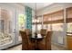 Cozy breakfast nook with a round table and wicker chairs, next to a patio exit at 22232 N 48Th St, Phoenix, AZ 85054