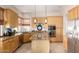 Well-lit kitchen featuring wood cabinets, granite countertops, and stainless steel appliances at 22232 N 48Th St, Phoenix, AZ 85054