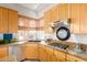 Bright kitchen featuring stainless steel appliances, granite countertops, and wood cabinetry at 22232 N 48Th St, Phoenix, AZ 85054