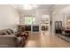 Cozy living room featuring a fireplace, built-in shelving, wood floors, neutral walls, and an open design at 22232 N 48Th St, Phoenix, AZ 85054