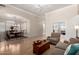 Spacious living room featuring an open layout with wood floors, neutral walls, and a view into the dining area at 22232 N 48Th St, Phoenix, AZ 85054