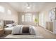 Bright main bedroom with large windows, neutral colors, ceiling fan, and decorative rug at 22232 N 48Th St, Phoenix, AZ 85054