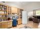 Home office with built-in bookshelves, spacious desk area, and an open doorway to the living room at 22232 N 48Th St, Phoenix, AZ 85054