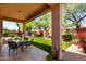 Inviting covered patio with tile flooring and outdoor dining area, overlooking a lush backyard at 22232 N 48Th St, Phoenix, AZ 85054