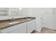 Bathroom featuring double sinks with granite countertops and white cabinetry at 22540 N Lynn St, Maricopa, AZ 85138