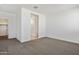 Spacious bedroom with neutral carpet and ample closet space at 22540 N Lynn St, Maricopa, AZ 85138