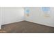 Cozy bedroom with carpet flooring and windows offering natural light at 22540 N Lynn St, Maricopa, AZ 85138